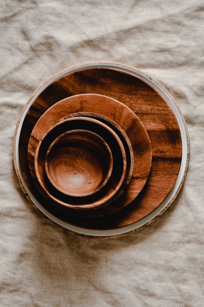 Wooden bowls displayed on a rustic linen cloth, capturing an earthy and minimalist kitchen aesthetic.